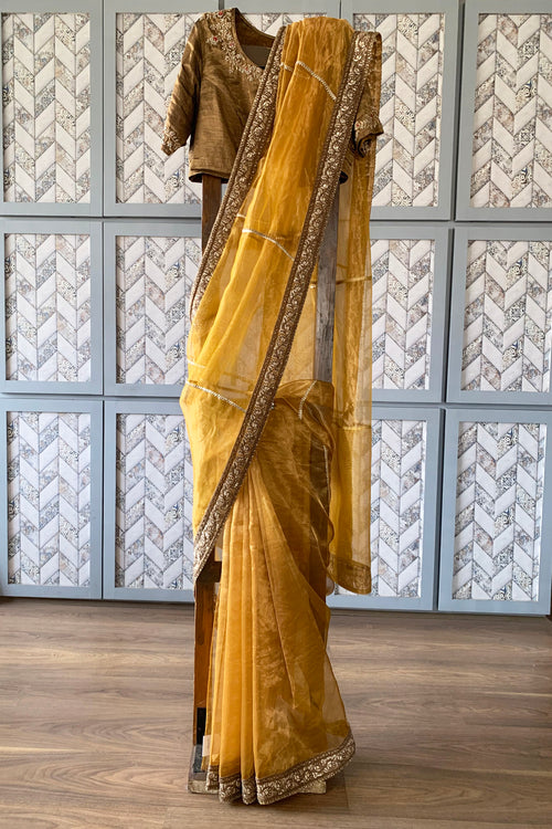 Gold tissue sari with rich border and gota lines